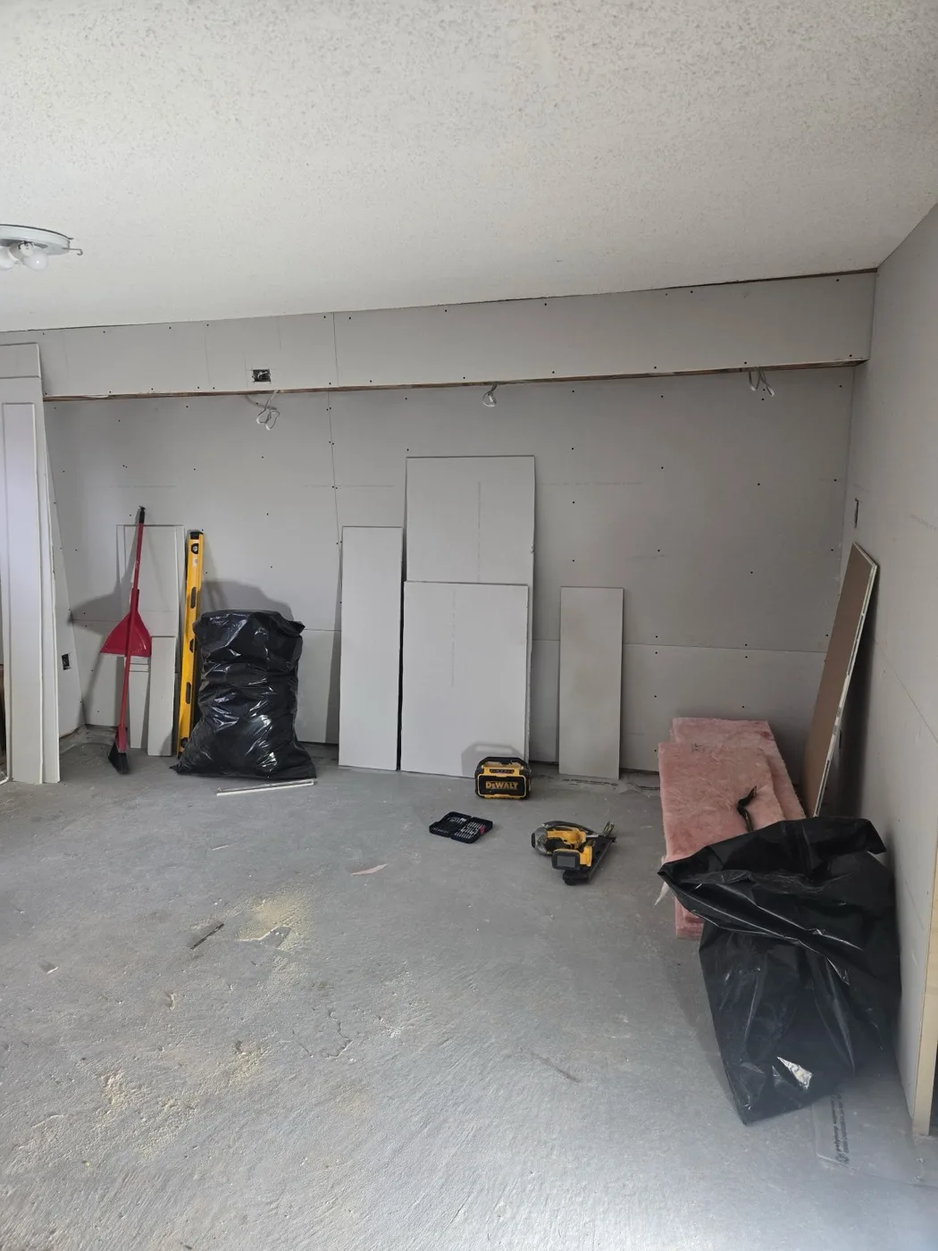 New drywall installed in a basement by Near North Construction and Stucco