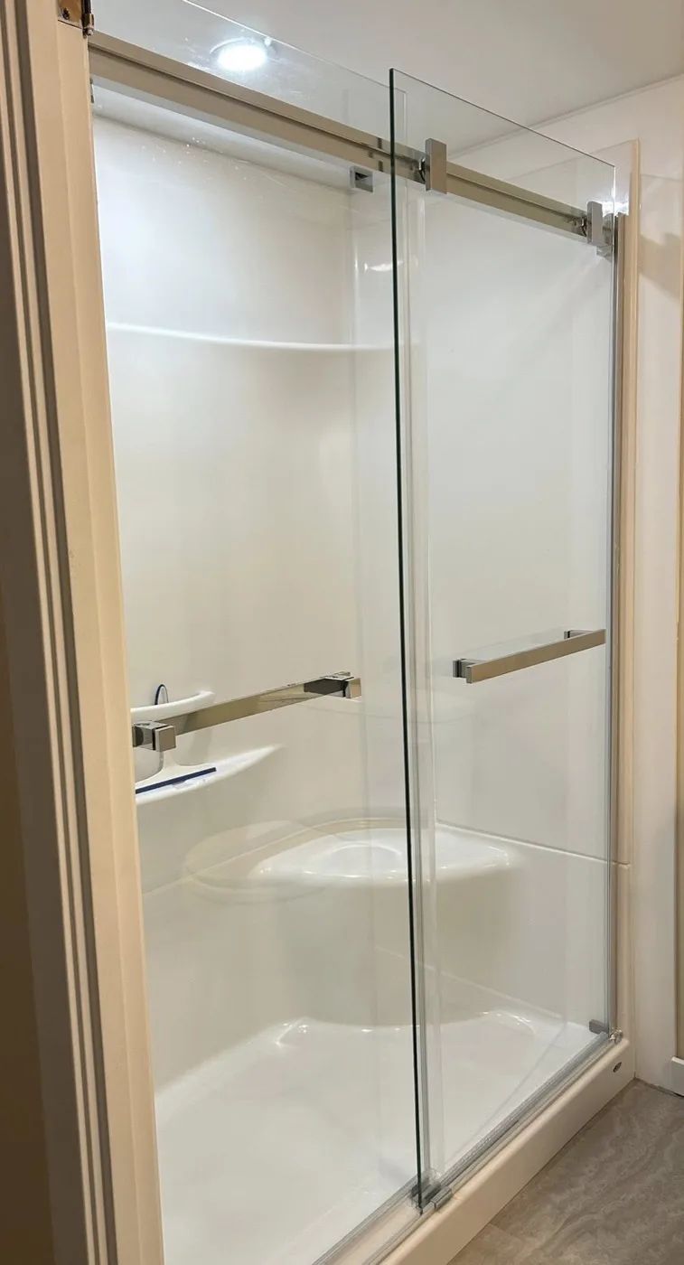Finished bathroom renovation with a glass shower enclosure by Near North Construction and Stucco