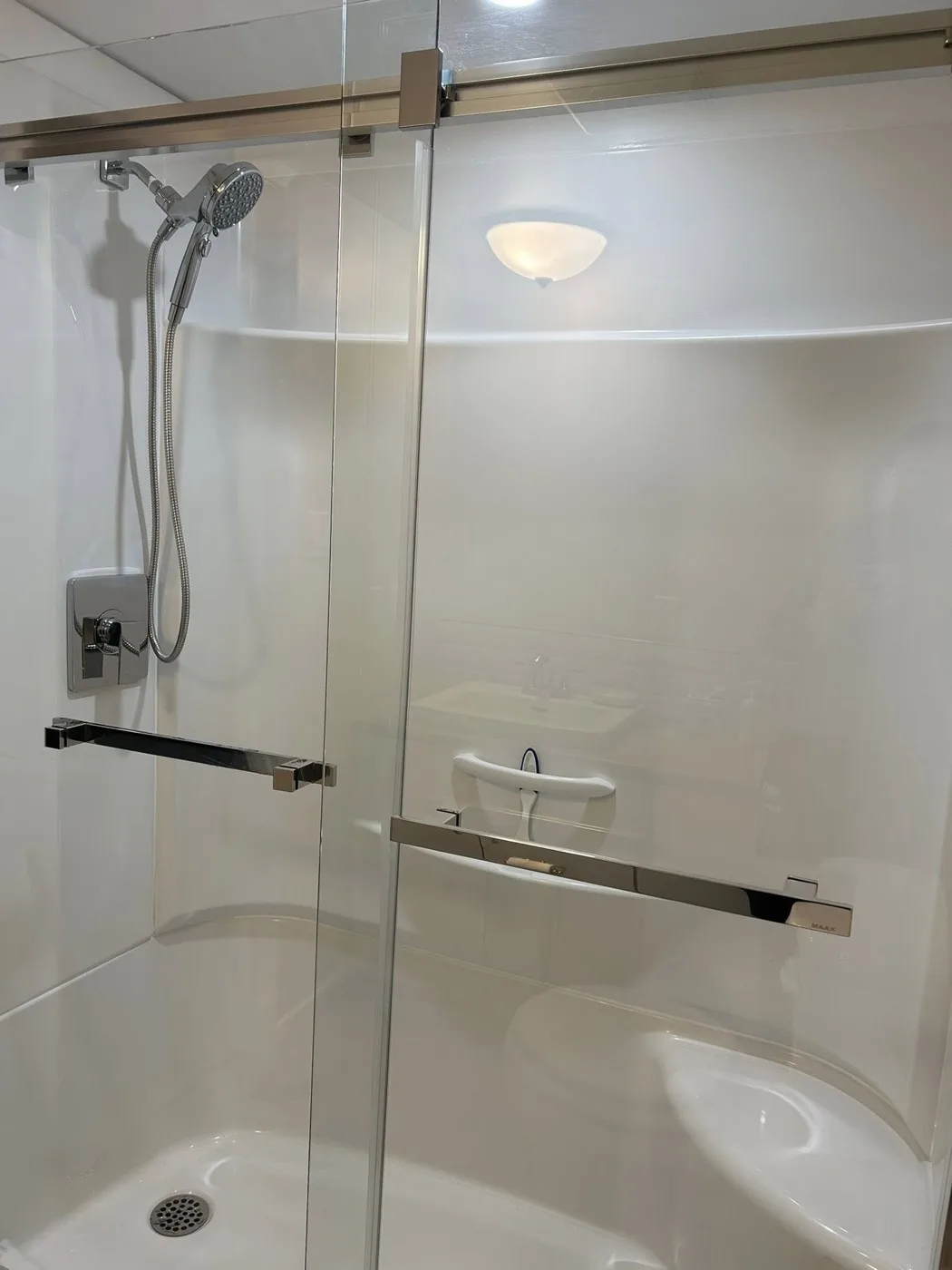 Bathroom shower renovation with new fixtures by Near North Construction and Stucco