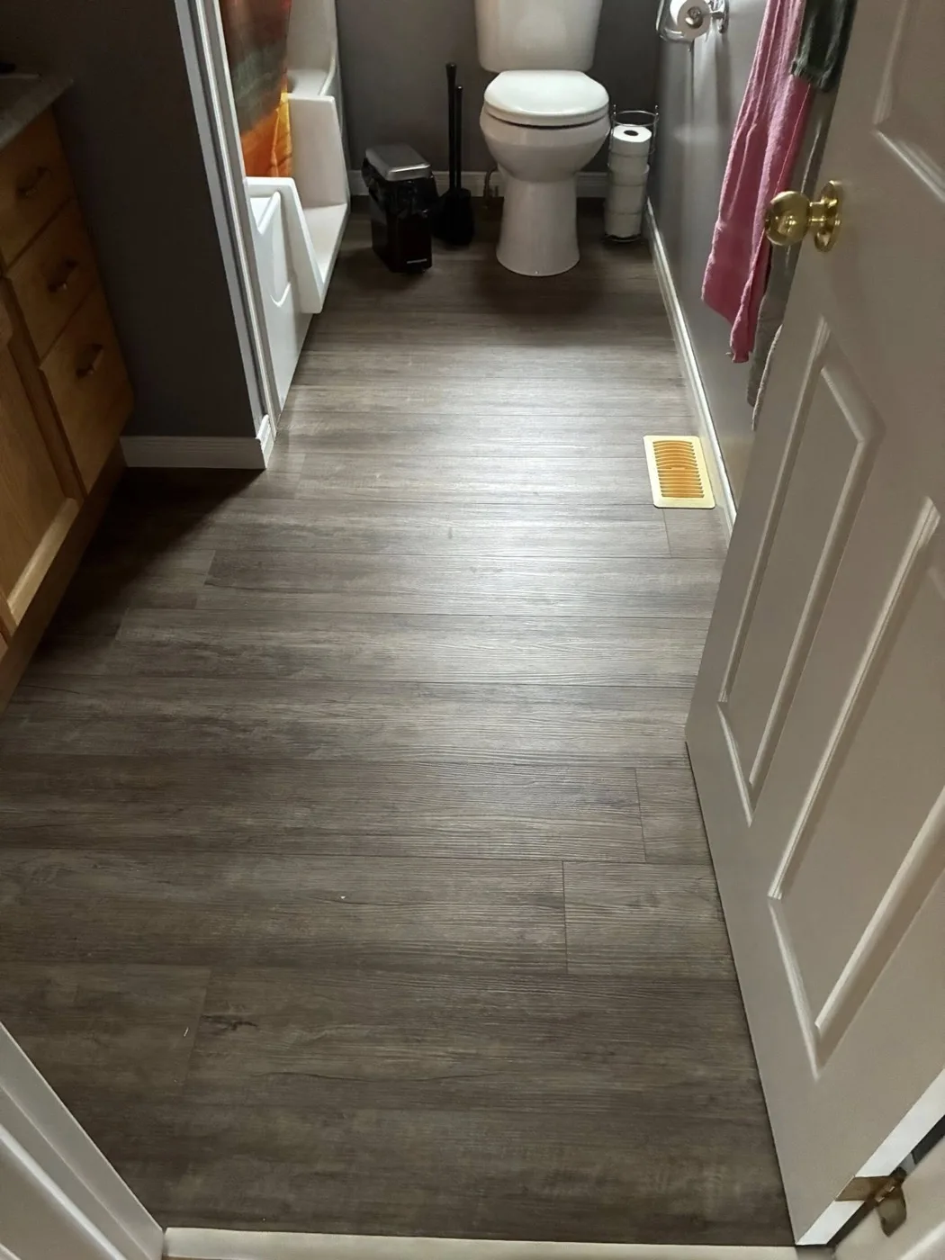 Bathroom vinyl plank flooring by Near North Construction and Stucco