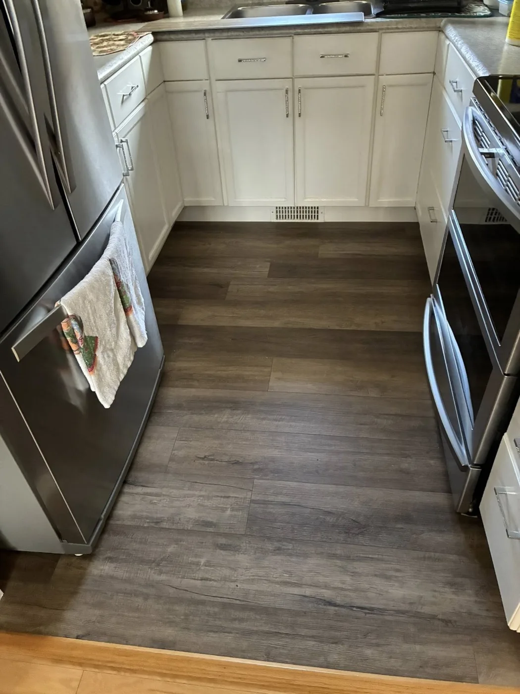 New vinyl plank flooring installed in a kitchen by Near North Construction and Stucco