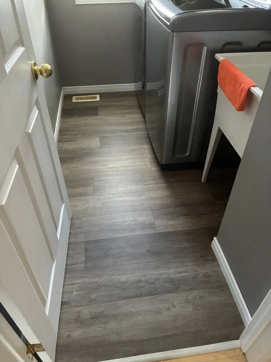 Laundry room vinyl plank flooring by Near North Construction and Stucco